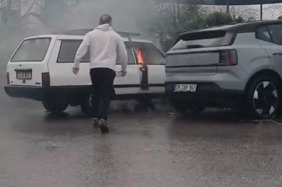 İzmir'de yanan otomobile yol kenarındaki su birikintisinden doldurduğu kovayla müdahale etti